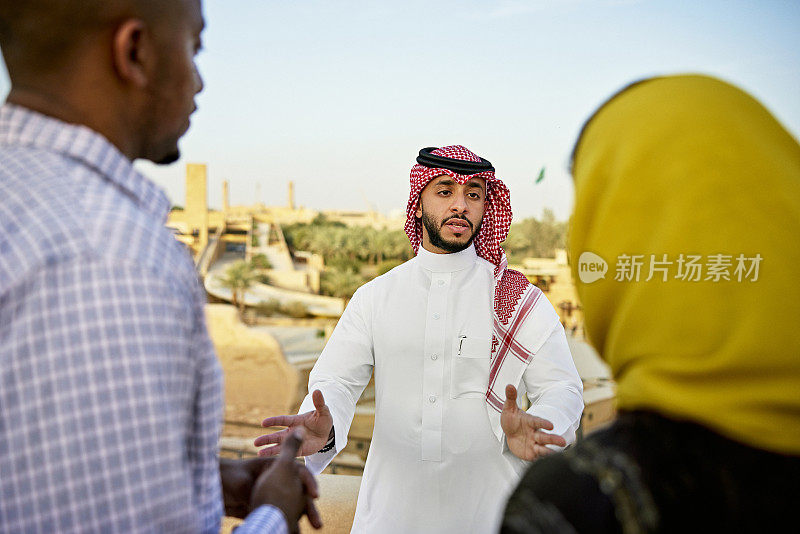 Tourists listening to guide describe At-Turaif ruins